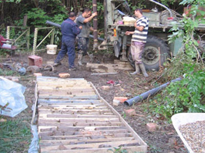 Setting the perforated part and precipitator in exploration borehole (front of the photos shows the core of anborehole in the box)