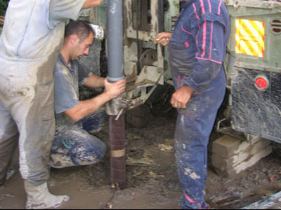 Lowering the perforated part and precipitator in exploration borehole